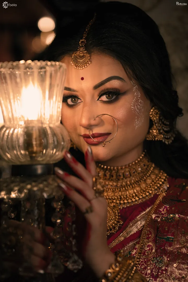 Intimate close-up bridal portrait beside a glowing lamp